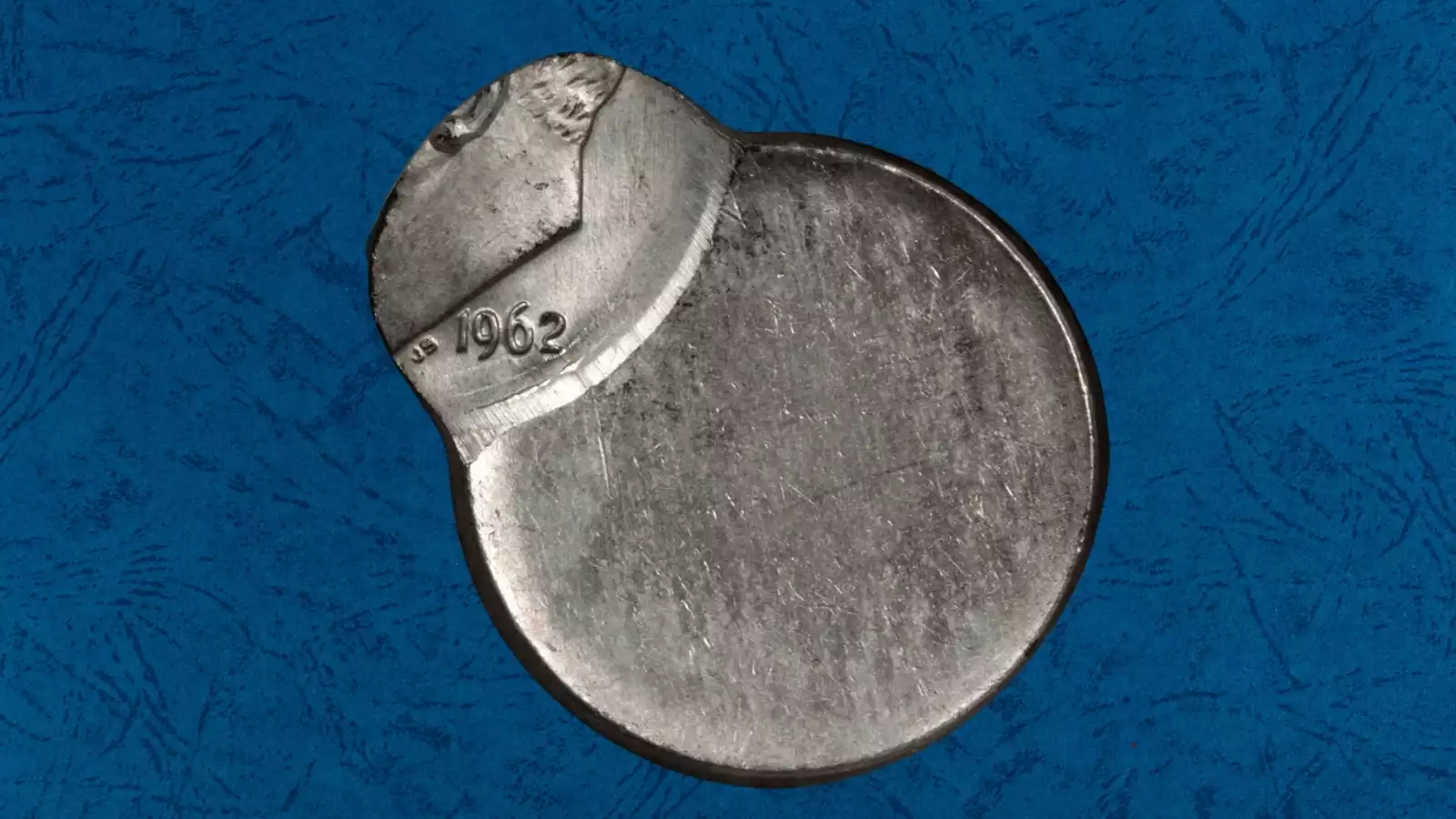 1962 Roosevelt dime off-center strike error showing design shifted off-center with blank planchet crescent visible