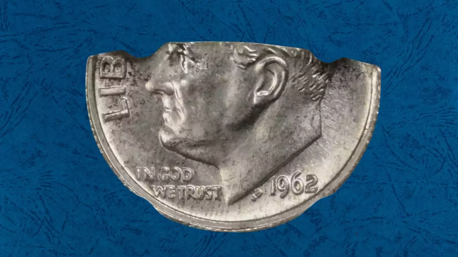 1962 Roosevelt dime curved clipped planchet error showing missing section at coin edge